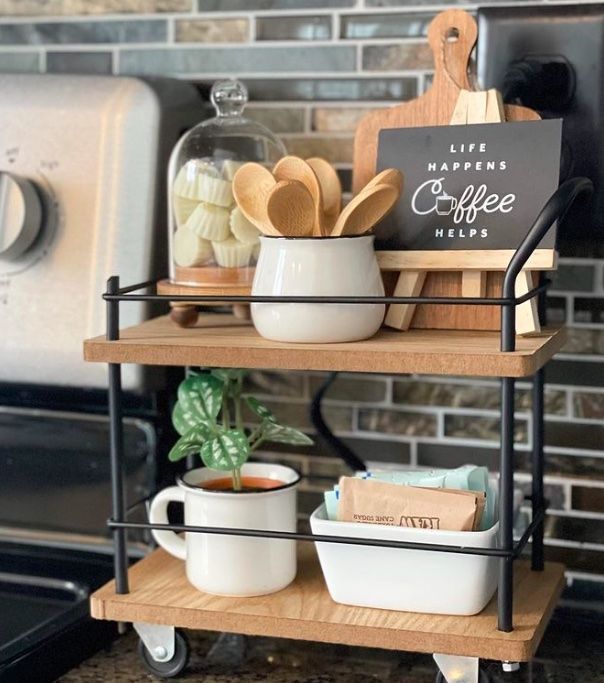 a kitchen shelf with coffee mugs and utensils on it in front of an oven