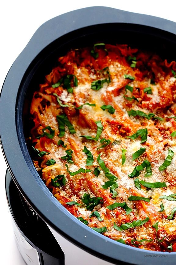 a casserole dish with meat, cheese and herbs in a crock pot