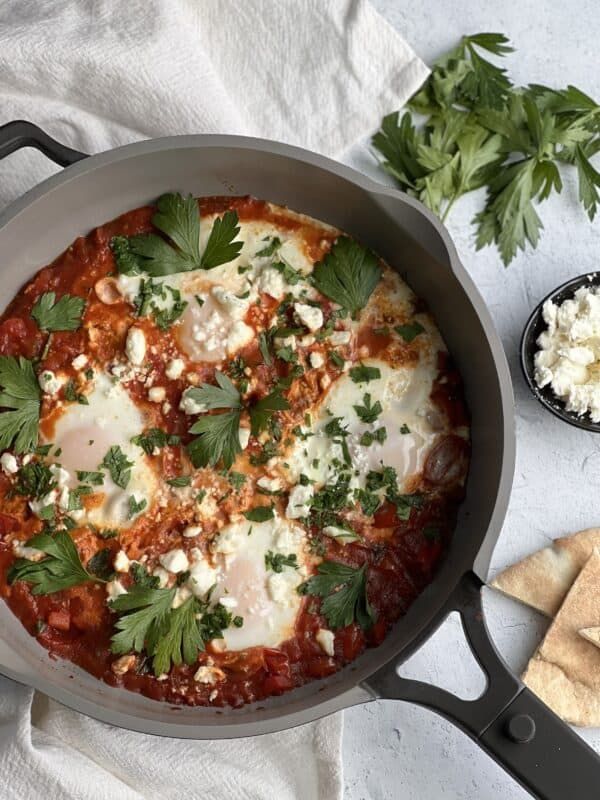 an image of easy shaksshuka recipe in a skillet with text overlay