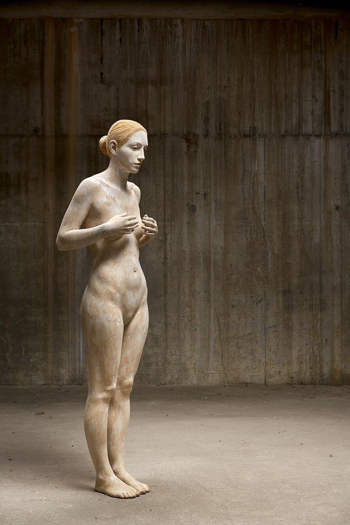 a statue is standing in an empty room