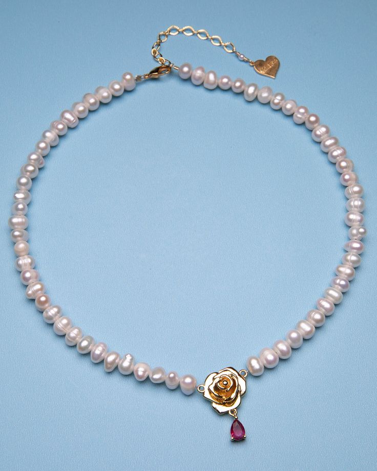 Add some flower power to your style with our Blooming Rose Pearl Necklace! This necklace features a delicate rose pendant adorned with a lustrous pearl center. Perfect for adding a touch of whimsy to any outfit. 18k gold-plated, cubic zirconia, Freshwater Pearls 14" Necklace| 2" extension chain | 18 mm Rose Handmade in Los Angeles with imported materials Follow these tips to keep your jewelry looking its best! Jewelry Pearls, Face Jewellery, Pearl Rose, Nameplate Necklace, Rose Pendant, Rose Necklace, Blooming Rose, Hand Chain, Bead Charm Bracelet