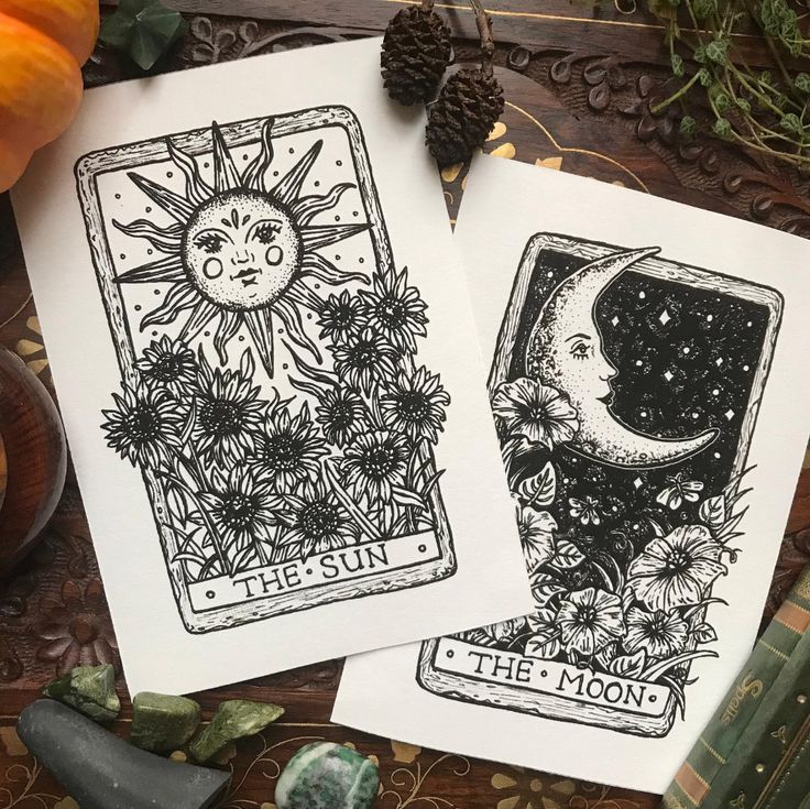 two tarot cards with the sun and the moon on them next to pumpkins