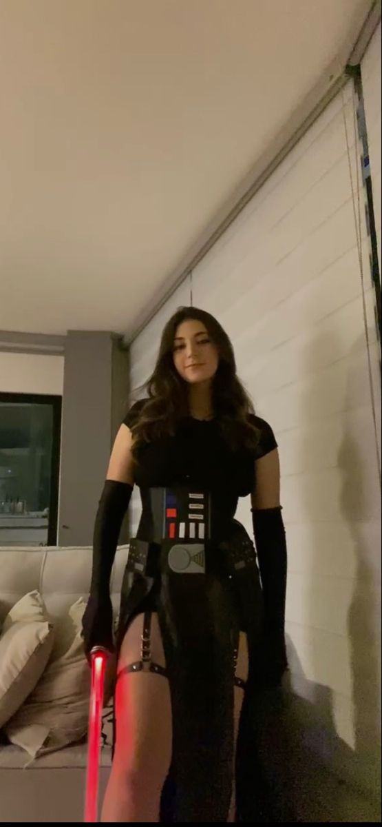 a woman dressed up as darth vader in a living room