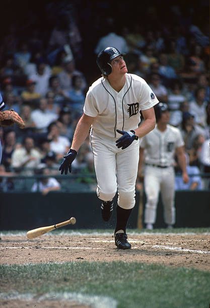 a baseball player holding a bat next to home plate