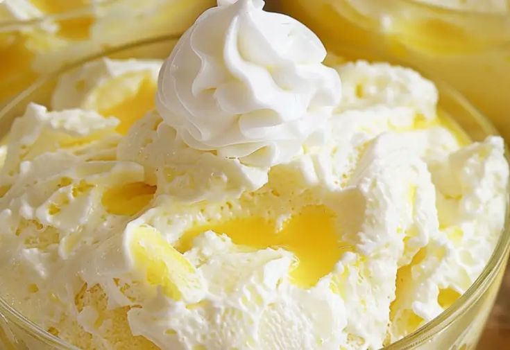 a bowl filled with whipped cream and lemons