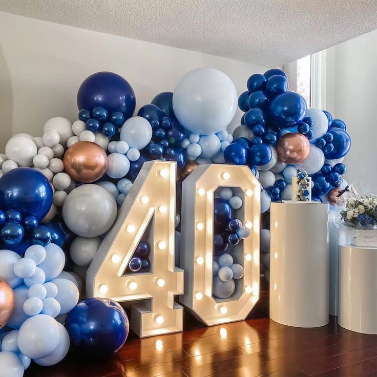 balloons and lights are arranged around the number forty