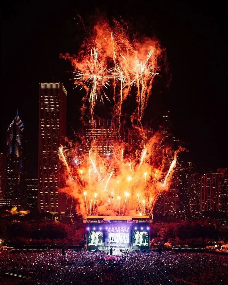 fireworks are lit up in the night sky at a concert