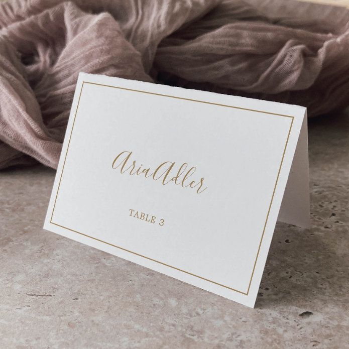 a table name card sitting on top of a counter next to a pile of blankets