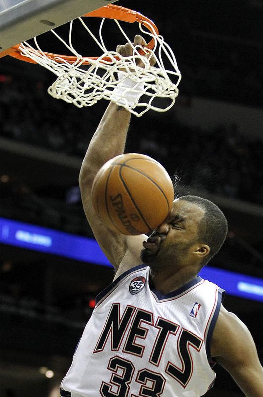 a man dunking a basketball in the air