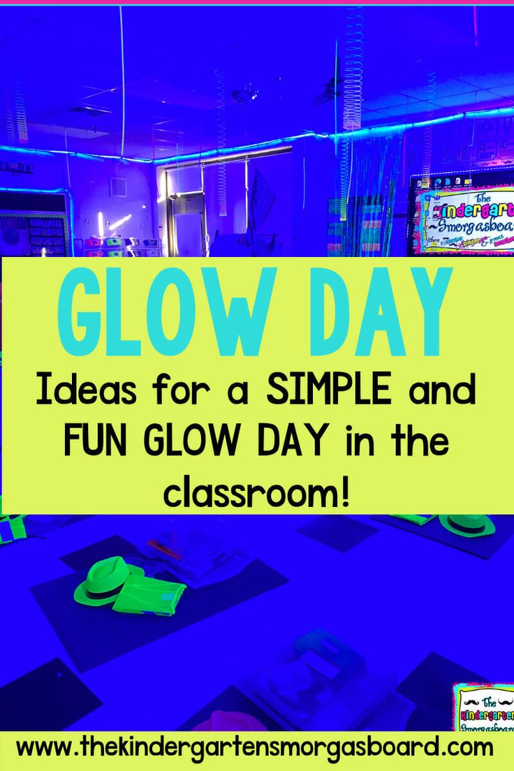 a classroom with neon blue and green glow day signs on the wall, bookshelves and desks