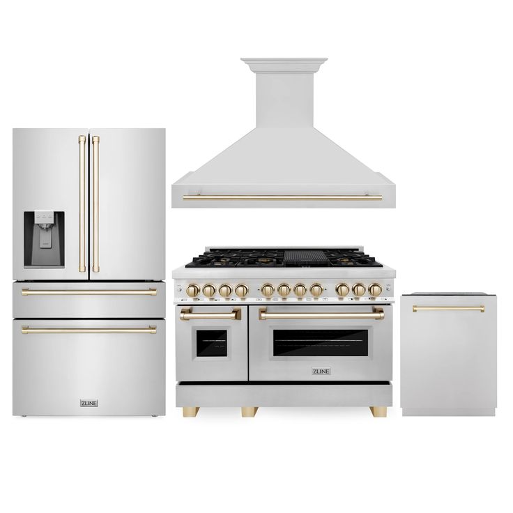 a white stove top oven sitting next to two refrigerators and an oven with gold trim