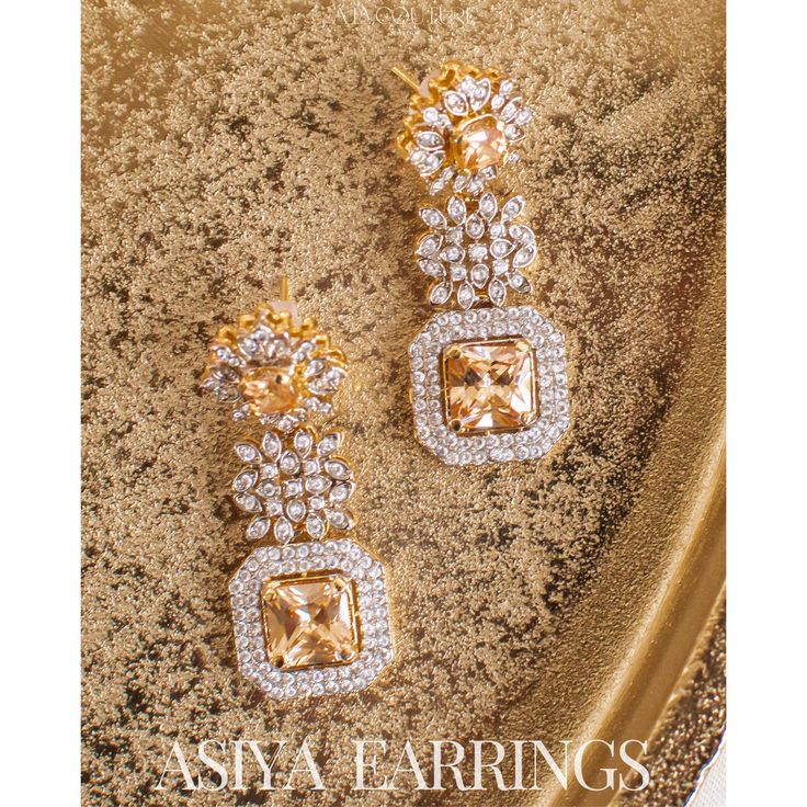 An exquisite testament to refined luxury! Meticulously crafted to exude opulence, these earrings glistens with an ethereal brilliance of CZ and champagne stones. Approximate earrings length is 2.1". Gold-plated on high quality brass as base metal. Made by order. Kindly allow 5-7 weeks for the delivery of this item. For custom or urgent requests, please contact support@alacouture.com. *Please Note: We use faux stones and beads in all of our jewelry. Gold Hand Set Cluster Earrings, Opulent Cubic Zirconia Jewelry For Parties, Opulent Cubic Zirconia Party Jewelry, Glamorous Formal Bridal Earrings With Sparkling Stones, Opulent Silver Earrings For Wedding, Glamorous Gold Plated Earrings For Weddings, Glamorous Gold Plated Wedding Earrings, Elegant Sparkling Jewelry For Celebration, Exquisite Diamond-accent Earrings For Party