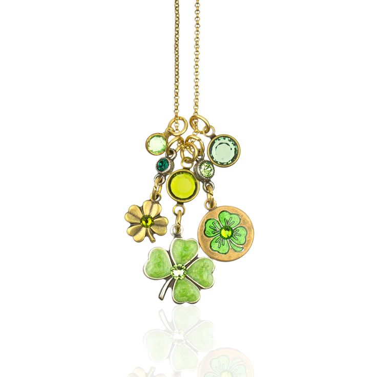 Take some good luck charms along the way in this charm necklace. Each jumble includes a hand enameled clover charm and clover medallion, with a tiny brilliant crystal accented clover, and crystal channels. Featuring gorgeous shades of green, this piece will complement your outfit with every swing and sway. Made in the USA with lead/nickel free antiqued brass findings and antiqued brass chain. Lobster claw closure. Crystal Colors: light green, green Enamel Colors: light green, transparent green Measures Approximately: Jumble 1 5/8″ L x 3/4″ W; Chain 16-18″ adjustable Style# NKJ118CLVR Good Luck Charms, Green Clover, Hamsa Necklace, Dragonfly Necklace, Clover Charm, Clover Green, Luck Charms, Silver Moon, Green Enamel