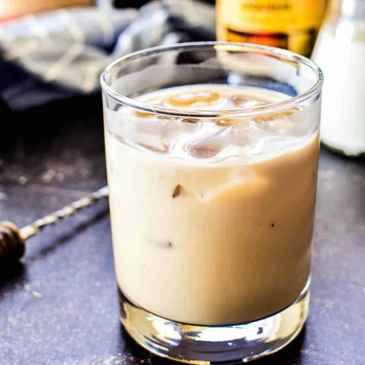 a close up of a drink in a glass on a table