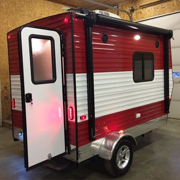 a red and white trailer parked in a garage