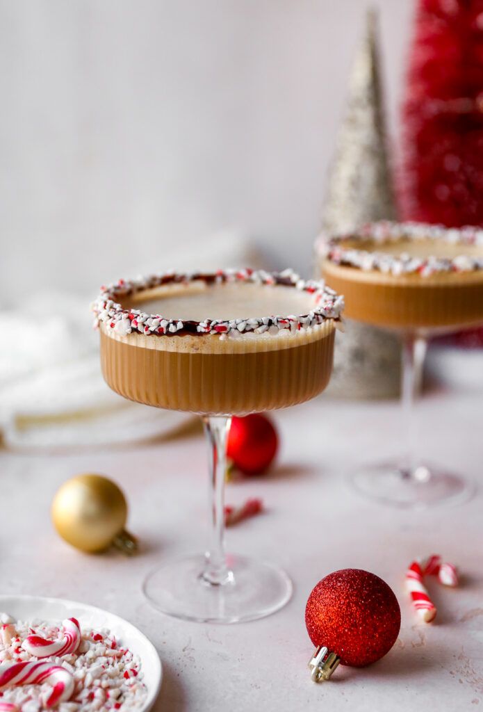 two desserts sitting on top of a table next to christmas decorations and candy canes