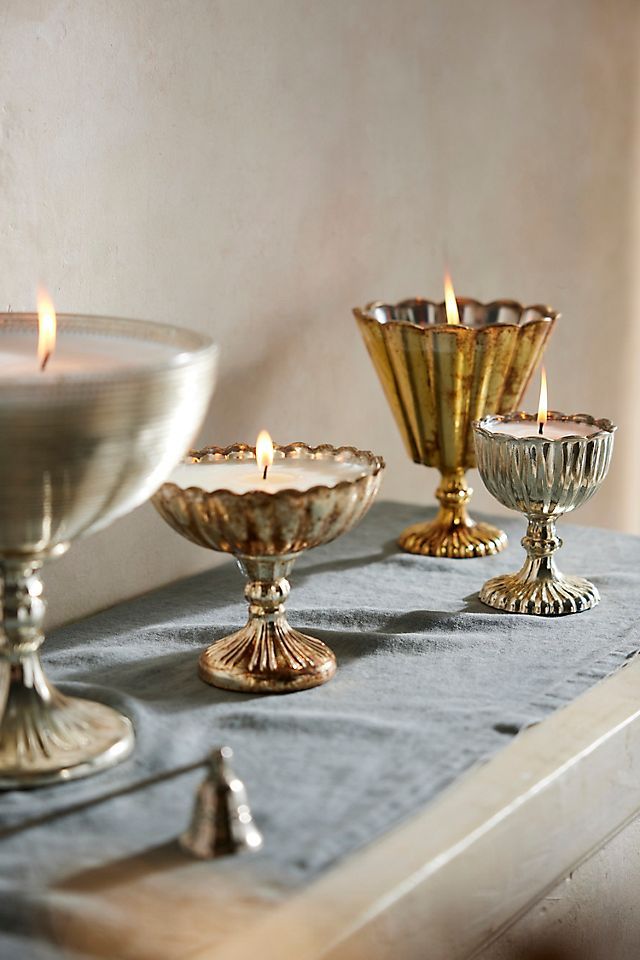 there are three candles on the table next to each other and one candle is lit