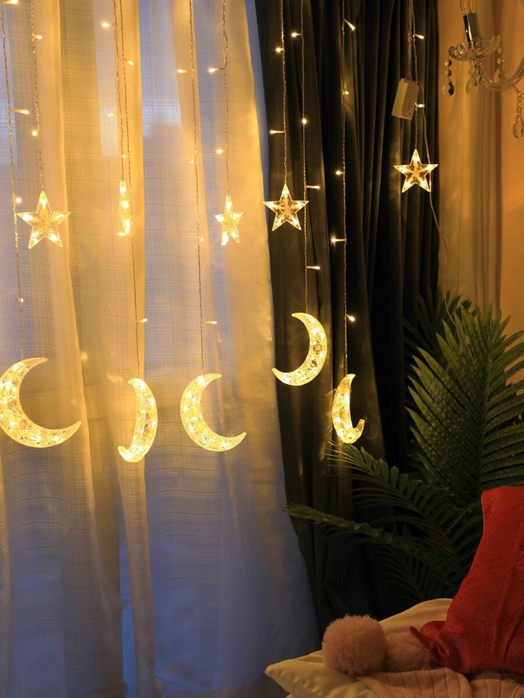 the curtains are decorated with stars and moon lights