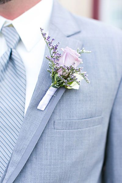 a man in a suit with a boutonniere on his lapel