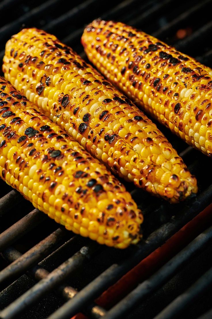 grilled corn on the cob is being cooked