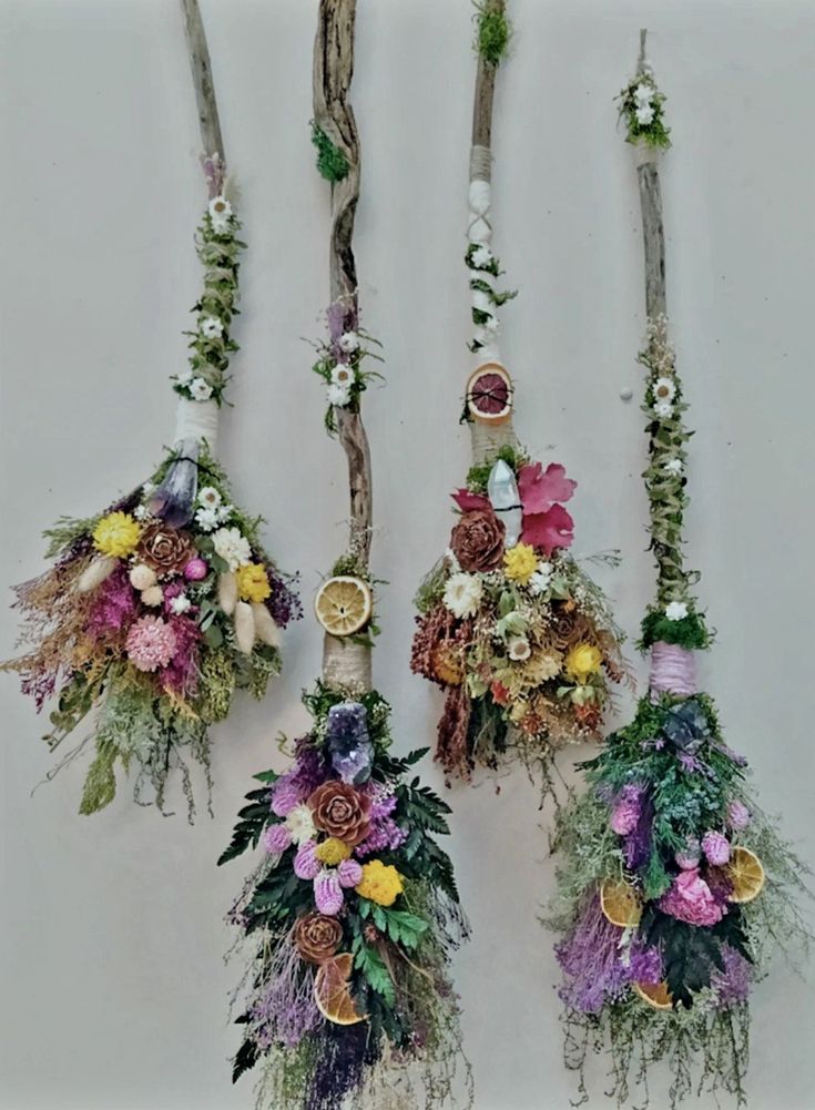 four different types of flowers hanging from branches