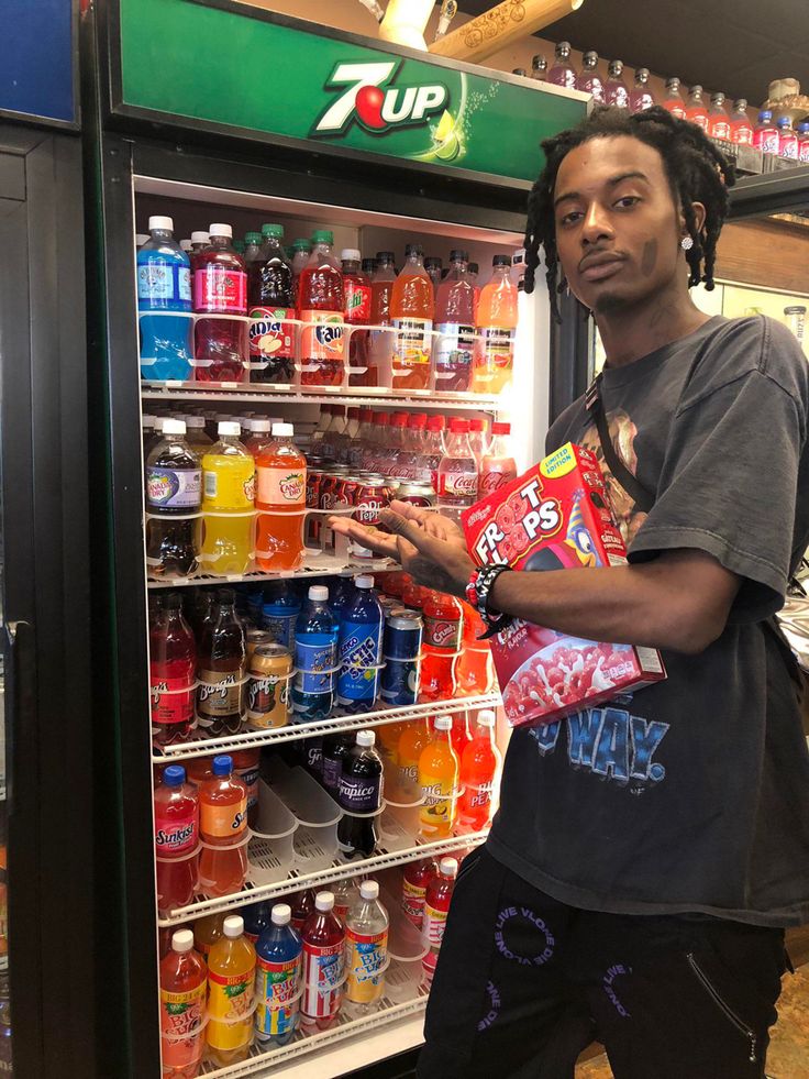 a man standing in front of a refrigerator filled with drinks