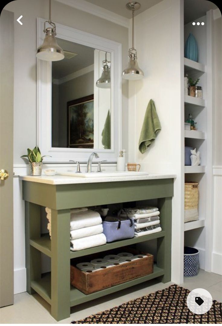 the bathroom is clean and ready to be used as a storage area for folded towels