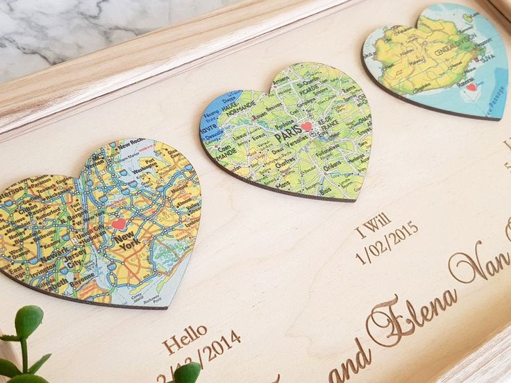 three wooden heart shaped magnets sitting on top of a table