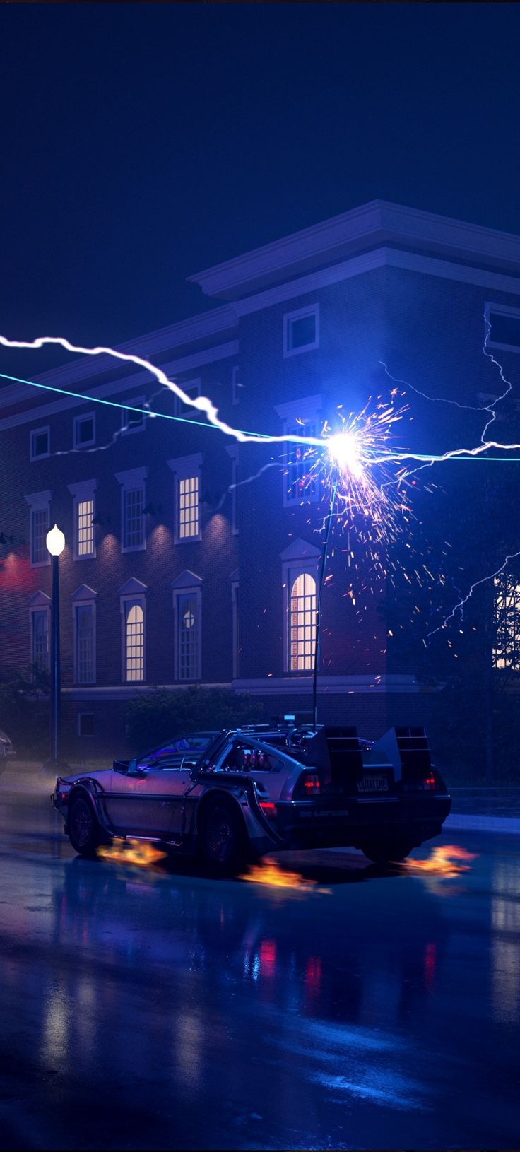 a police car parked in front of a building at night with a firework display