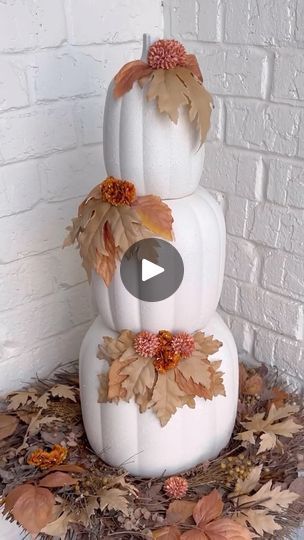 a three tiered white pumpkin decorated with leaves