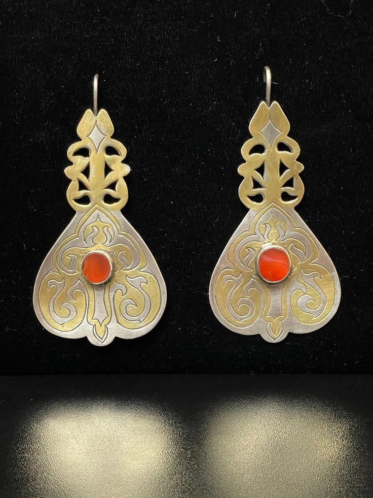 "Vintage Turkmen Tekke Tribal Earrings, made of silver and partially gilded silver with a red Carnelian stone, hand pierced Large Silver Earrings, Boho Chic Earrings, Collectable, Huge Tribal Earrings Length: 4\" Width: 2\" I am offering you these Turkmen traditional 925 Sterling Silver earrings, %100 handcrafted craftsmanship with Beautiful Carnelian Stones with fabulous craftsmanship Open studio most days from 10:00 to 5:00, DM make an appointment to have an adventure in shopping. Yes ~ along Elegant Silver Carnelian Earrings, Traditional Silver Carnelian Jewelry, Traditional Carnelian Jewelry For Formal Occasions, Silver Carnelian Earrings, Silver Carnelian Drop Earrings, Traditional Engraved Teardrop Earrings, Ceremonial Sterling Silver Earrings, Ceremonial Sterling Silver Hallmarked Earrings, Red Earrings With Intricate Design For Ceremonial Occasions