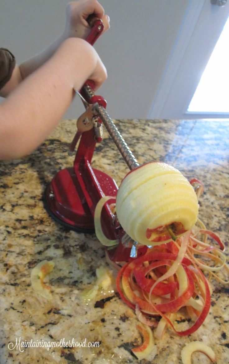 a person is using a vegetable slicer on a counter