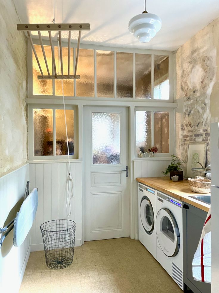 a washer and dryer in a small room next to a kitchen counter top