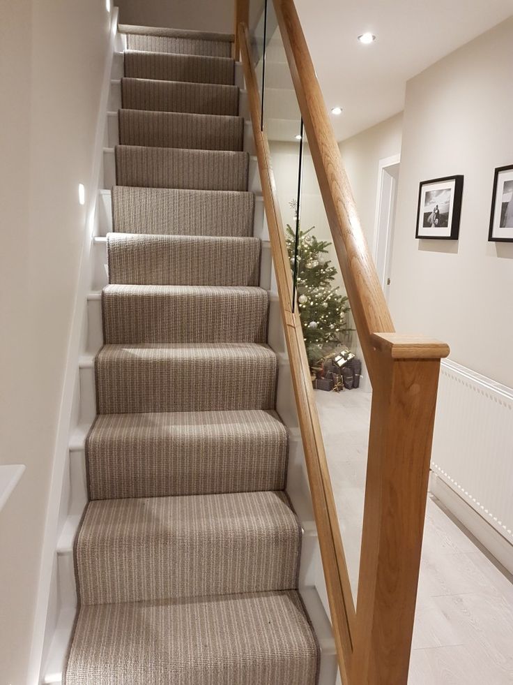 a staircase with carpeted steps and framed pictures on the wall