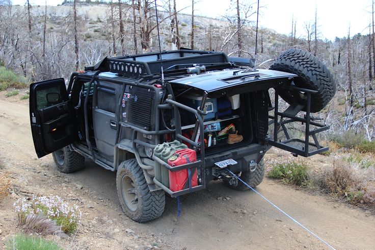 an off road vehicle is parked on the side of a dirt road