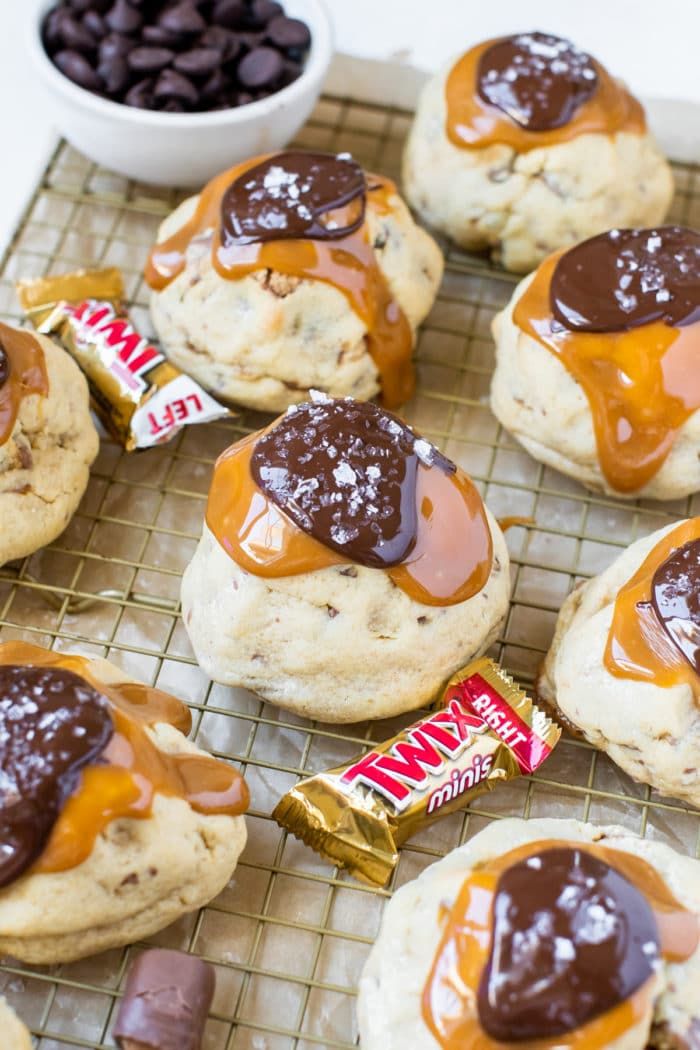 cookies with caramel and chocolate on a cooling rack