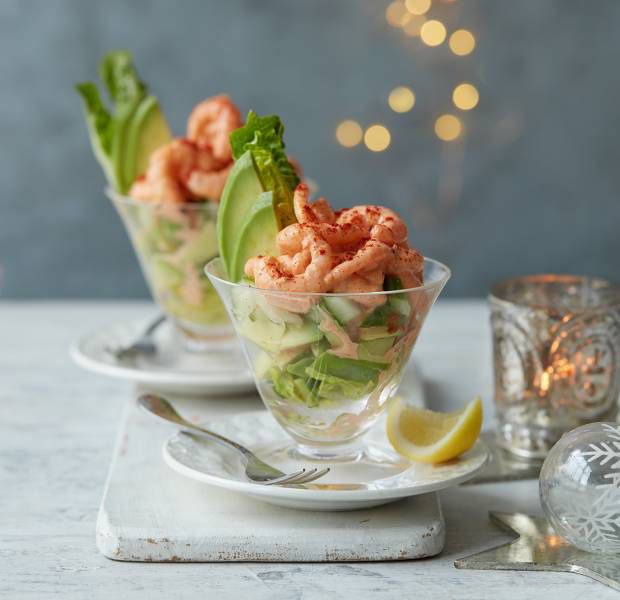 shrimp salad with cucumber and avocado served in small glass bowls on white plates