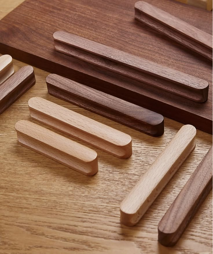 several wooden dowks are arranged on a wood surface, including one that has been cut in half