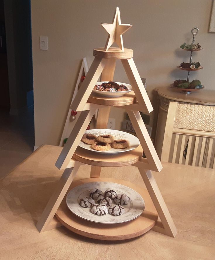 three tiered wooden christmas tree with donuts on plates