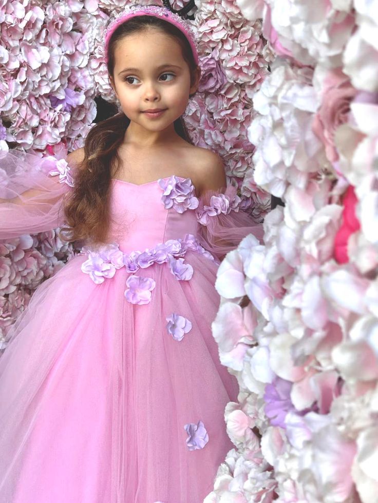 Introducing the enchanting Sanjana Flower Girl Tulle Dress, a masterpiece from Blush Kids that merges fairy-tale elegance with contemporary charm, and it comes with Free Shipping! This exquisite dress features a luxurious satin bodice that gently hugs the silhouette, leading to a romantic sweetheart neckline that captivates at first glance. The magic doesn't end there; Victorian long tulle sleeves drape gracefully, adding a touch of old-world glamour and mystery to the ensemble. But the true all Spring Fairytale Fairy Dress For Dress-up, Spring Princess Tulle Gown, Pink Tulle Princess Dress For Fancy Dress Occasions, Princess Style Tulle Fairy Dress Ball Gown, Elegant Pink Tutu Dress For Garden Party, Garden Party Tulle Princess Dress With Floral Applique, Garden Party Princess Dress With Floral Applique, Pink Princess Dress With Fitted Bodice, Pink Tulle Dress For Garden Party