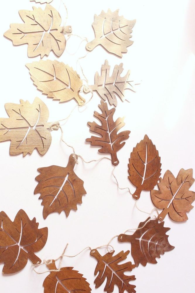 several wooden leaves are hanging on a string