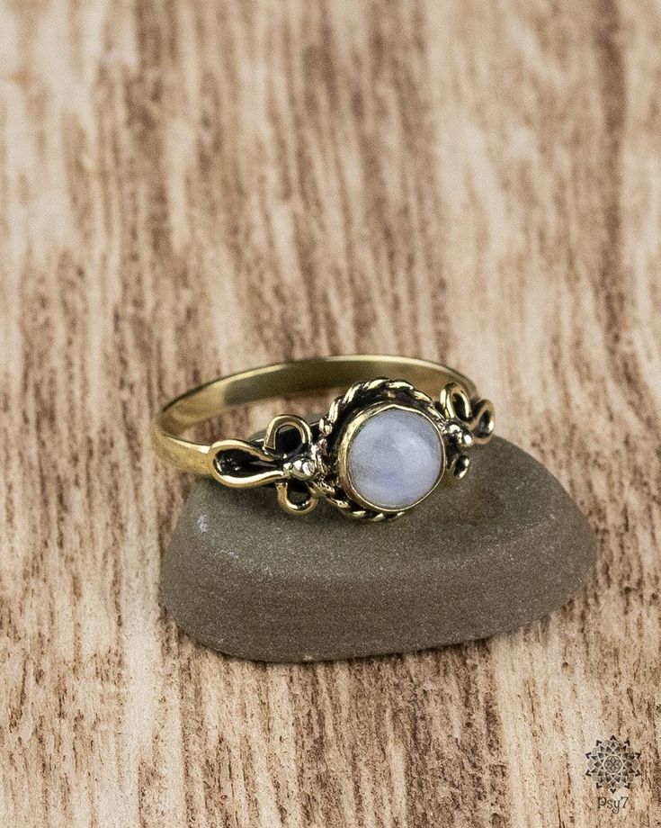 Filigree worked brass ring with embedded Moonstone. The setting of the gemstone is open towards the finger.  Material: brass - nickel & cadmium free Semi-precious stone: Moonstone Produced under fair conditions in India  To avoid disappointment, please note that colors and contrasts may look different depending on which monitor the photos are viewed on.   How do I determine my ring size?  The easiest way is to place a ring that fits you on a ruler and determine the inner diameter. Multiply this Gold Rings With Gemstone In Brass, Hand Forged Gold Moonstone Rings, Spiritual Gold Moon-shaped Ring, Antique Brass Gemstone Jewelry, Spiritual Moon Shaped Gold Ring, Spiritual Gold Moon Shaped Ring, Gold Midi Rings With Gemstone Round Shape, Gold Midi Rings With Gemstone, Hand Forged Round Moonstone Ring