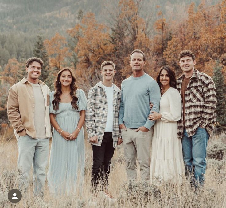 a group of people standing next to each other in a field