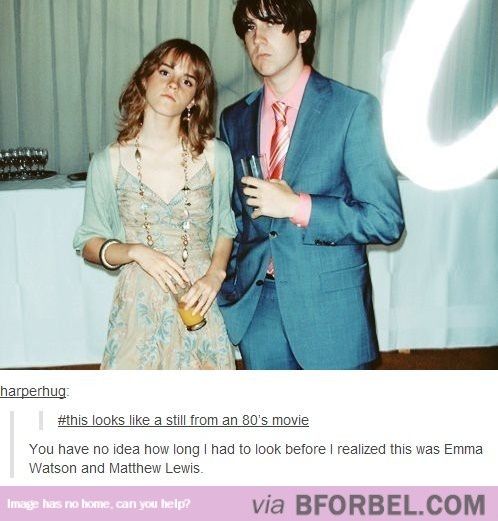 a man and woman standing next to each other in front of a table with drinks