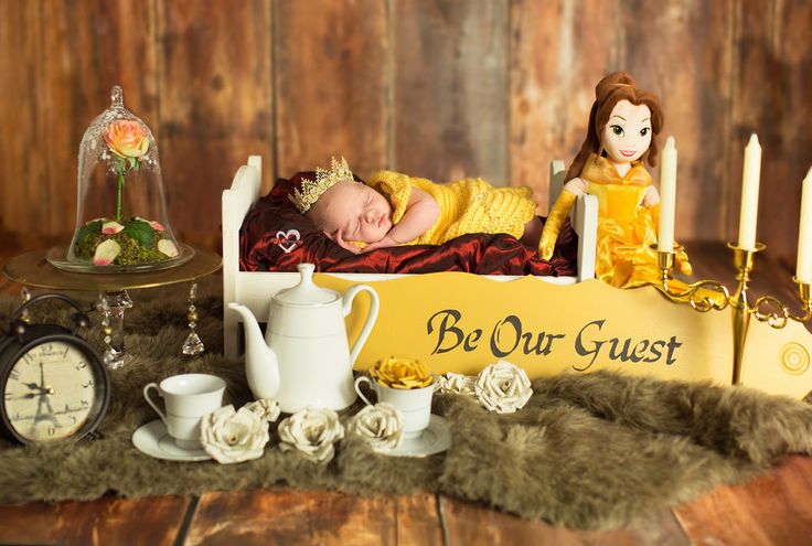 a baby is sleeping in a bed with candles and other items on the table next to it