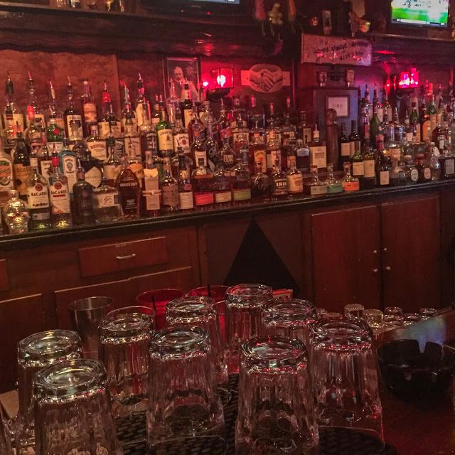 many glasses are lined up in front of the bar