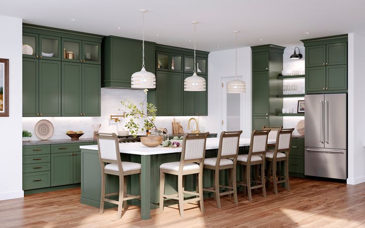 a large kitchen with green cabinets and white counter tops, along with wooden flooring