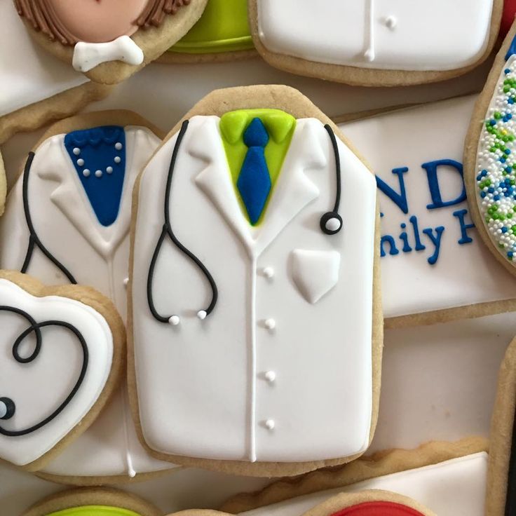 decorated cookies with doctor's coat and stethoscopes on them are displayed