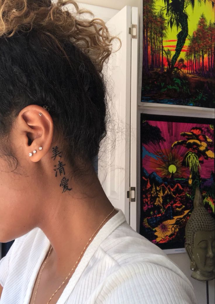 a woman with a tattoo on her left ear