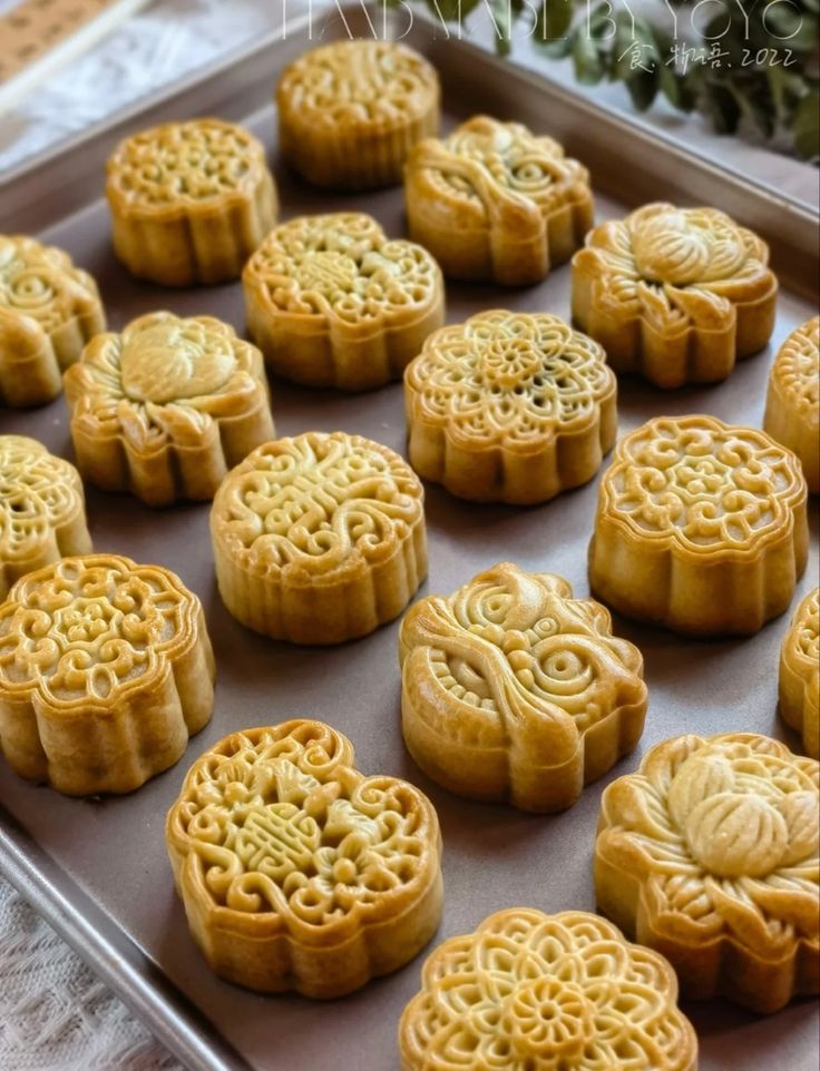 there are many moon cakes on the tray